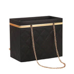 Black handbag with gold chain strap on a white background