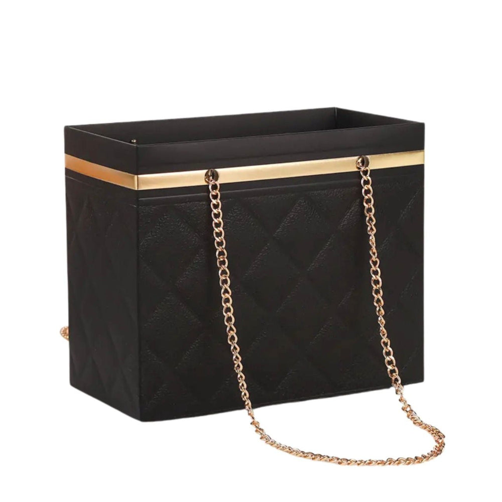 Black handbag with gold chain strap on a white background