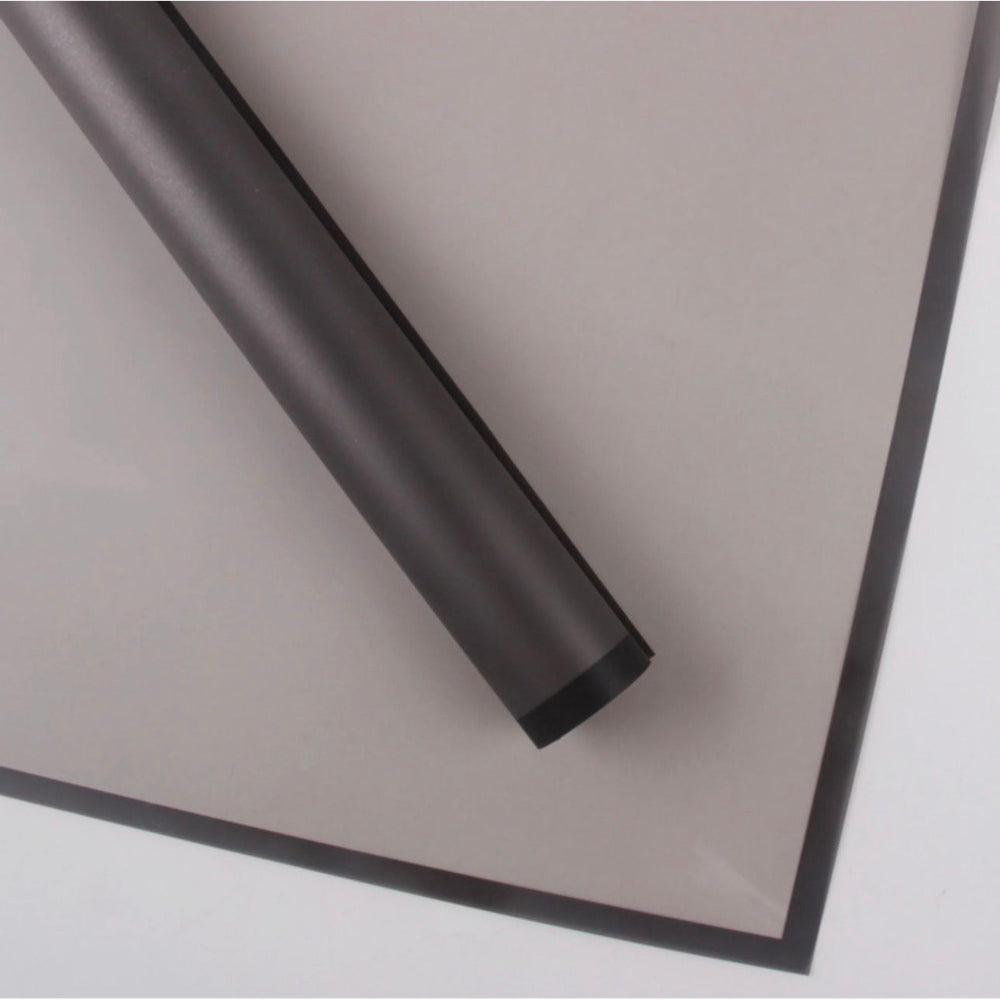 Roll of black plastic sheeting on a white background