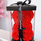 Teddy bear built with roses in a transparent box
