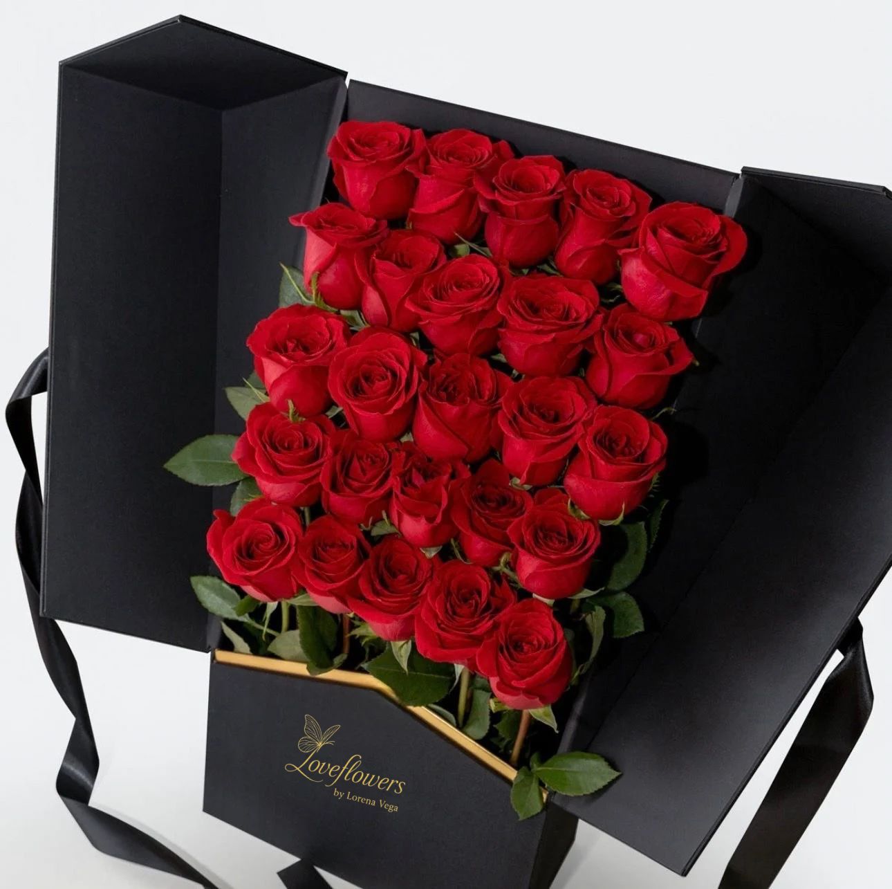Bouquet of red roses in a black box with Loveflowers branding.