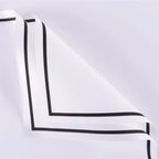 White fabric with black trim on a light gray background