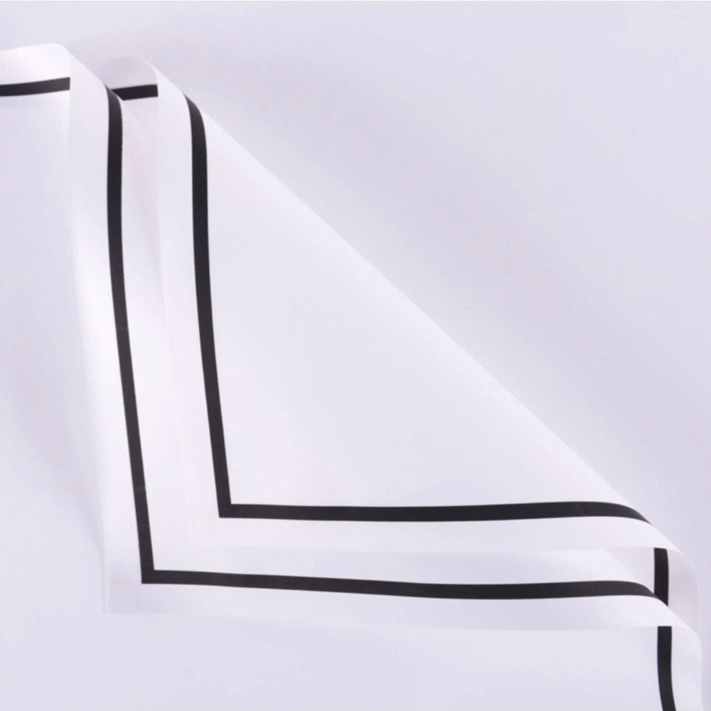 White fabric with black trim on a light gray background